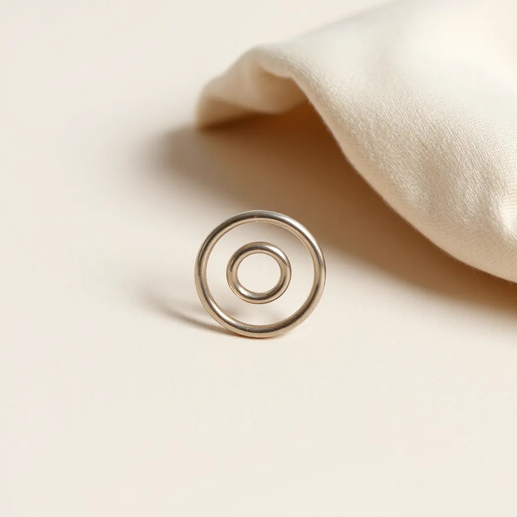 Adjustable spiral ring with a visible spiral design on a neutral background